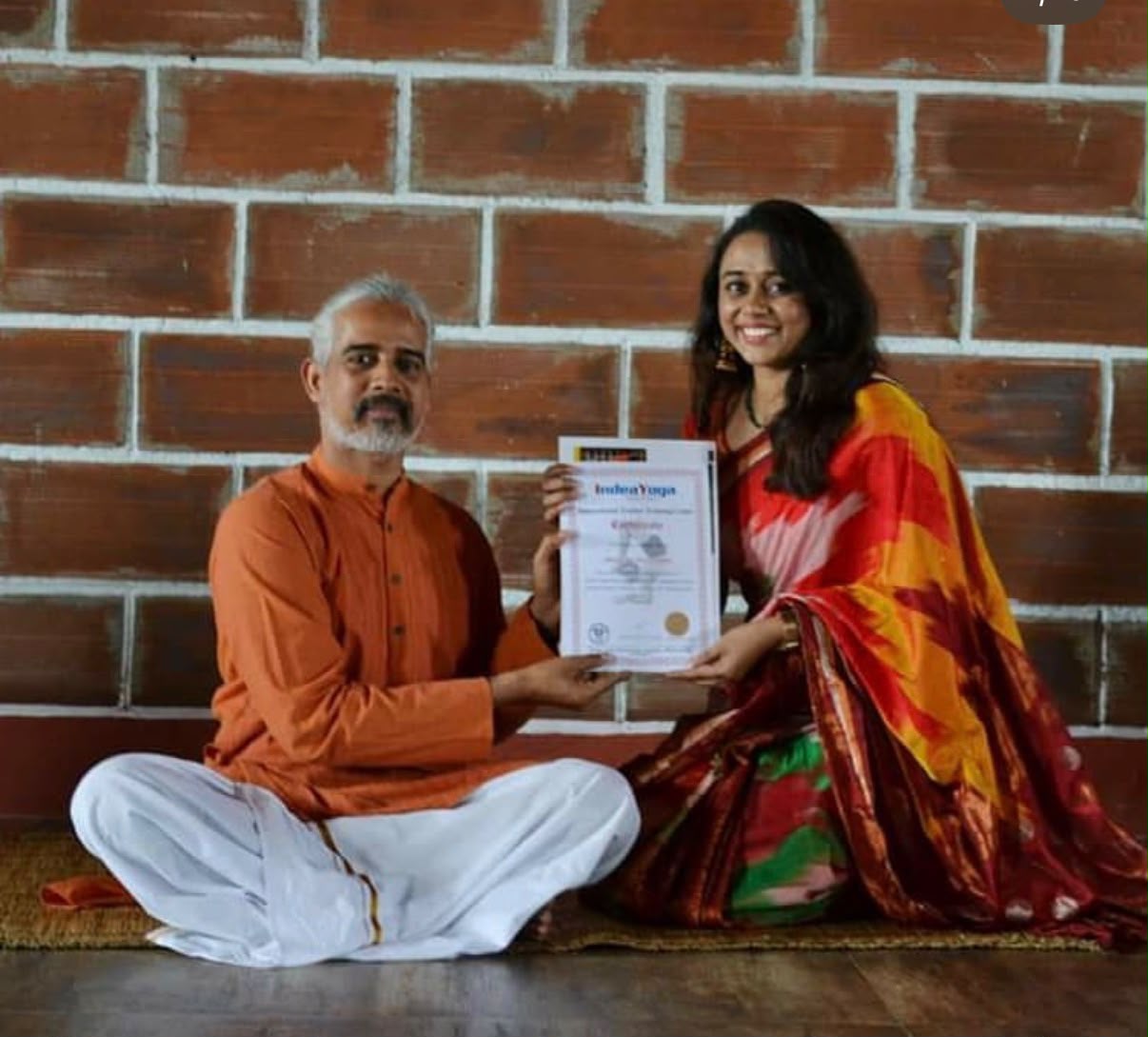 Receiving her yoga teacher training certificate from her guru at IndeaYoga